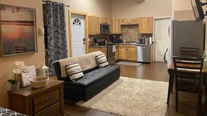 A compact living space with a sofa, a dining table, and a kitchenette. - Heartland studio in North Pole, Alaska - plus extras  (North Pole)