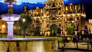 A historic building with intricate architecture, a central fountain, and a well-maintained garden. - Hostal Monumental (Cajamarca)