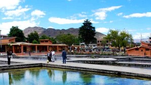 A public square with a central water feature, surrounded by buildings with a traditional architectural style. - Hostal Monumental (Cajamarca)