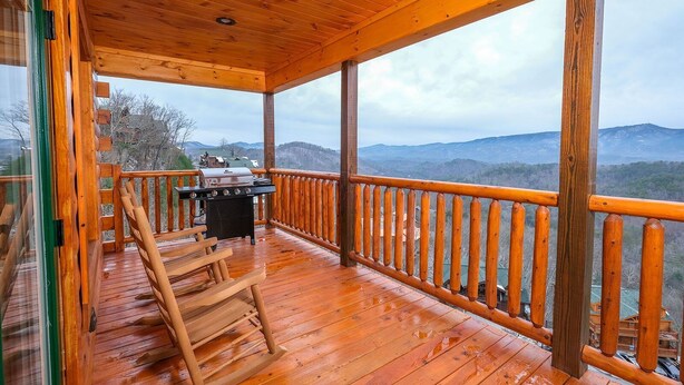 A wooden deck with a grill and chairs, overlooking a mountainous landscape. - Private Poolside Bliss & Mountain Views! - A Splash of Heaven (Sevierville)