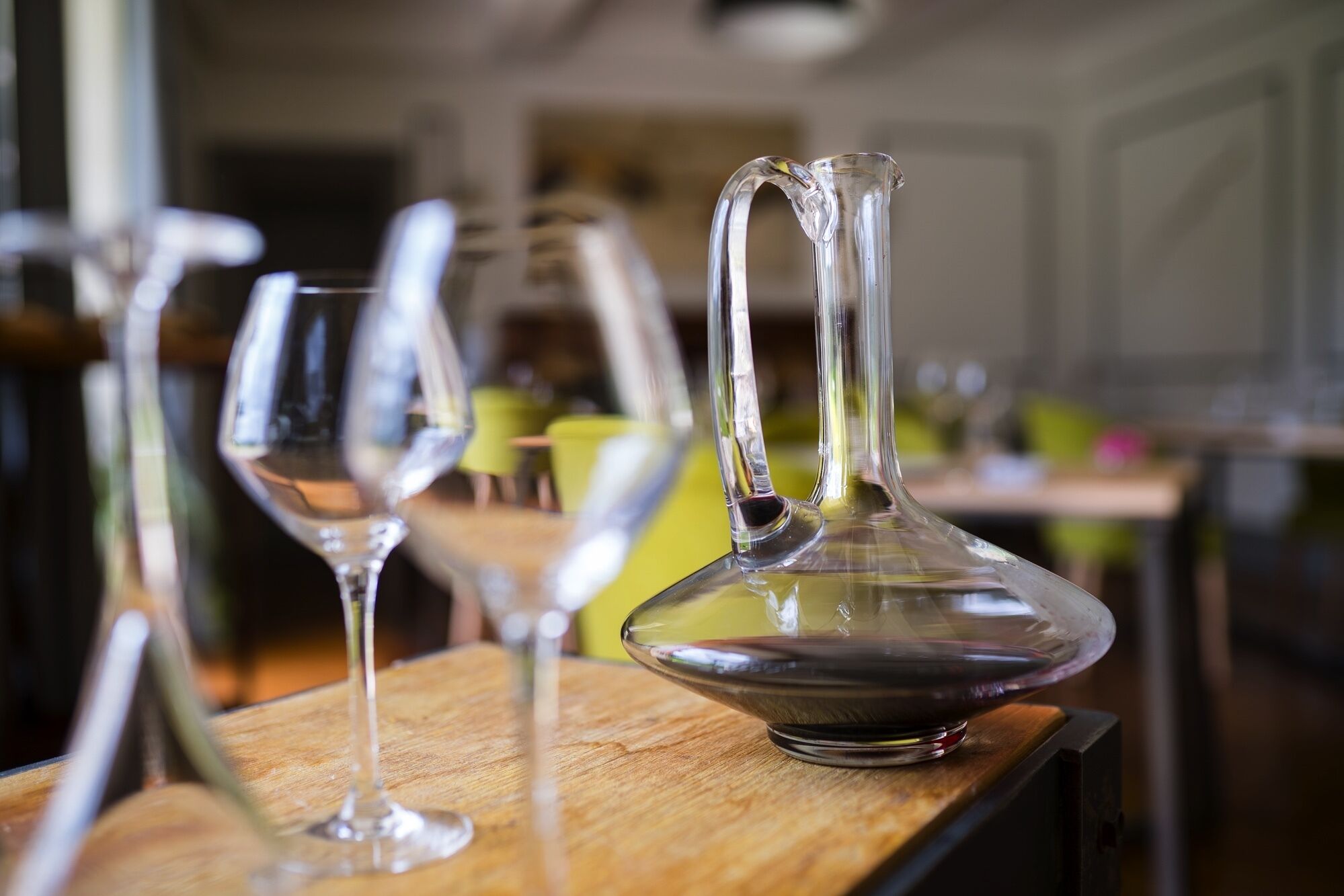 A dining table with clear glassware and a pitcher.
