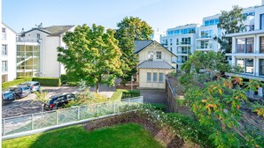 A residential area with modern buildings, a tree-lined street, and parked cars. - Inselstrand, App. 314 (Heringsdorf)
