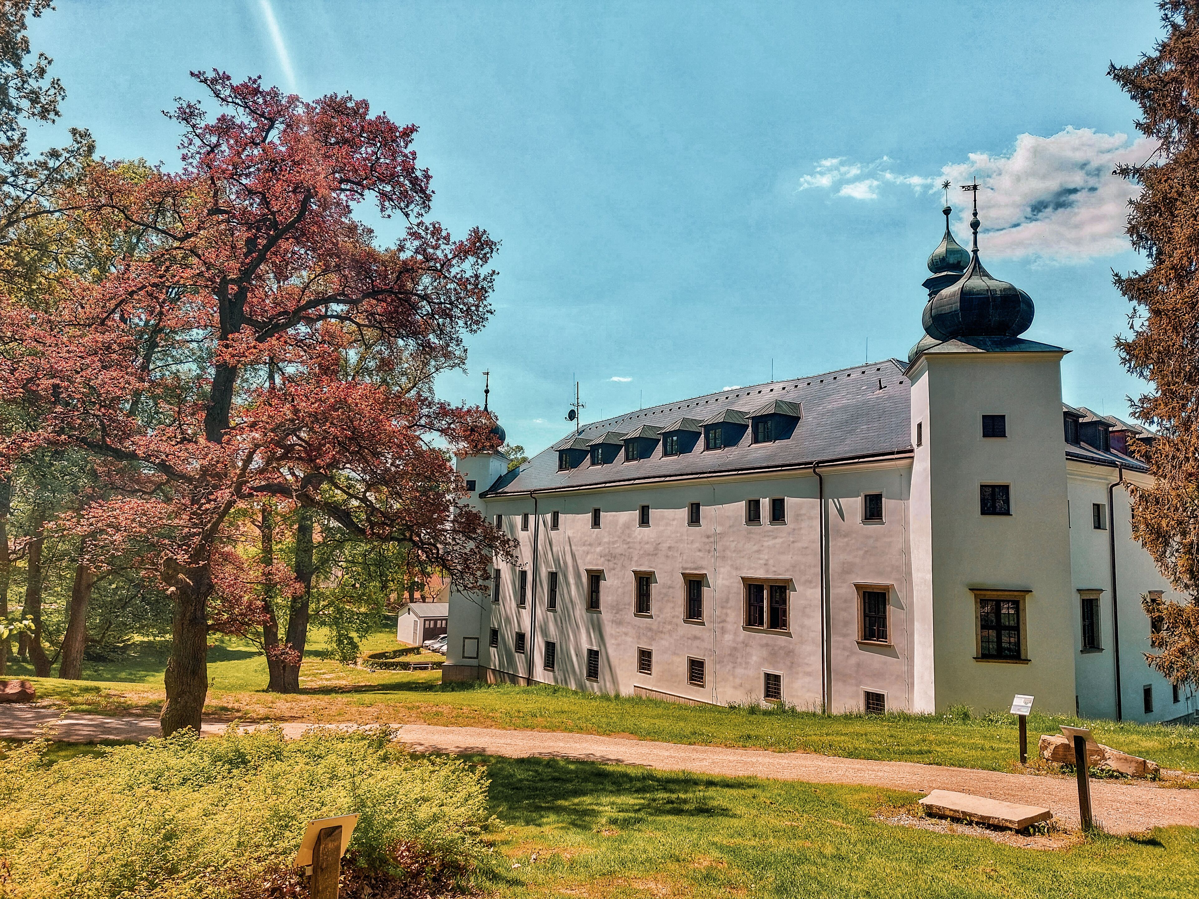 A large, historic building with a central tower and multiple windows.