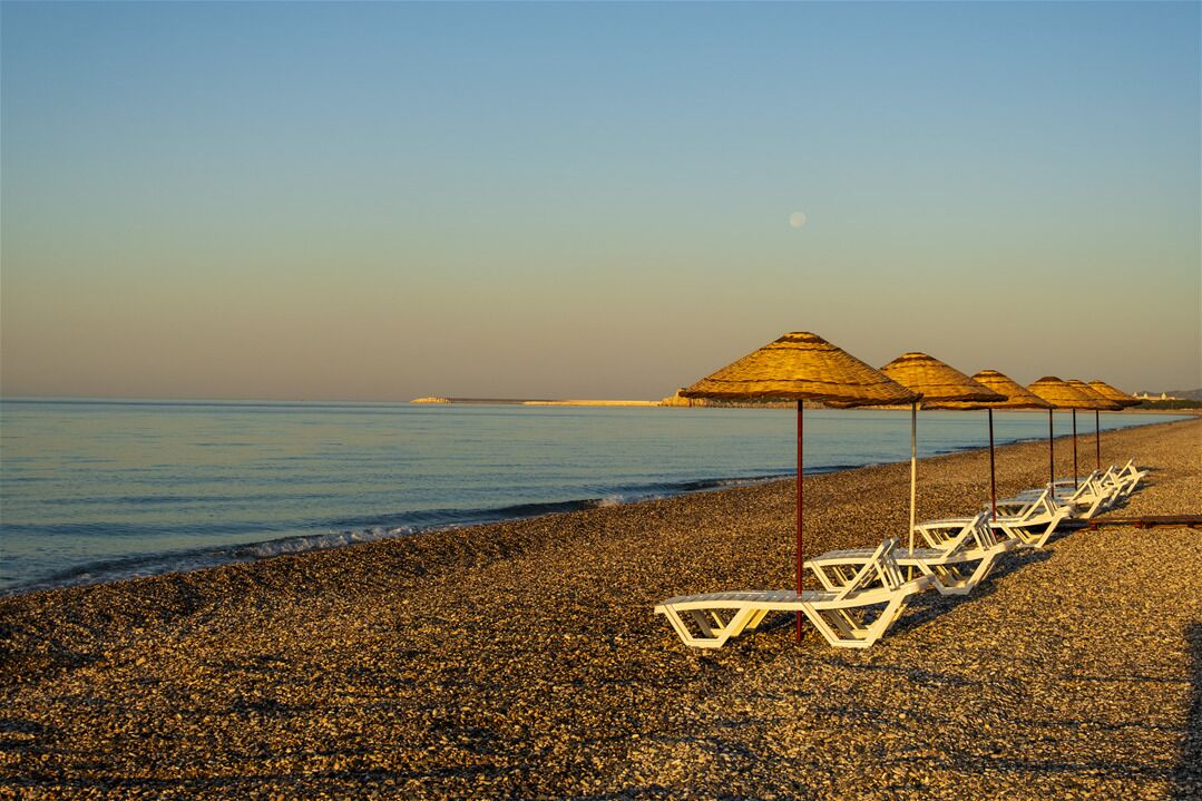Private beach, black sand, sun loungers, beach umbrellas