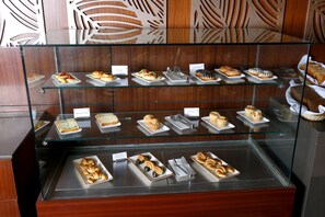 A bakery display case with various baked goods. - Alivaa Hotel, Millennium City Center, Sector 29, Gurugram (Gurugram)