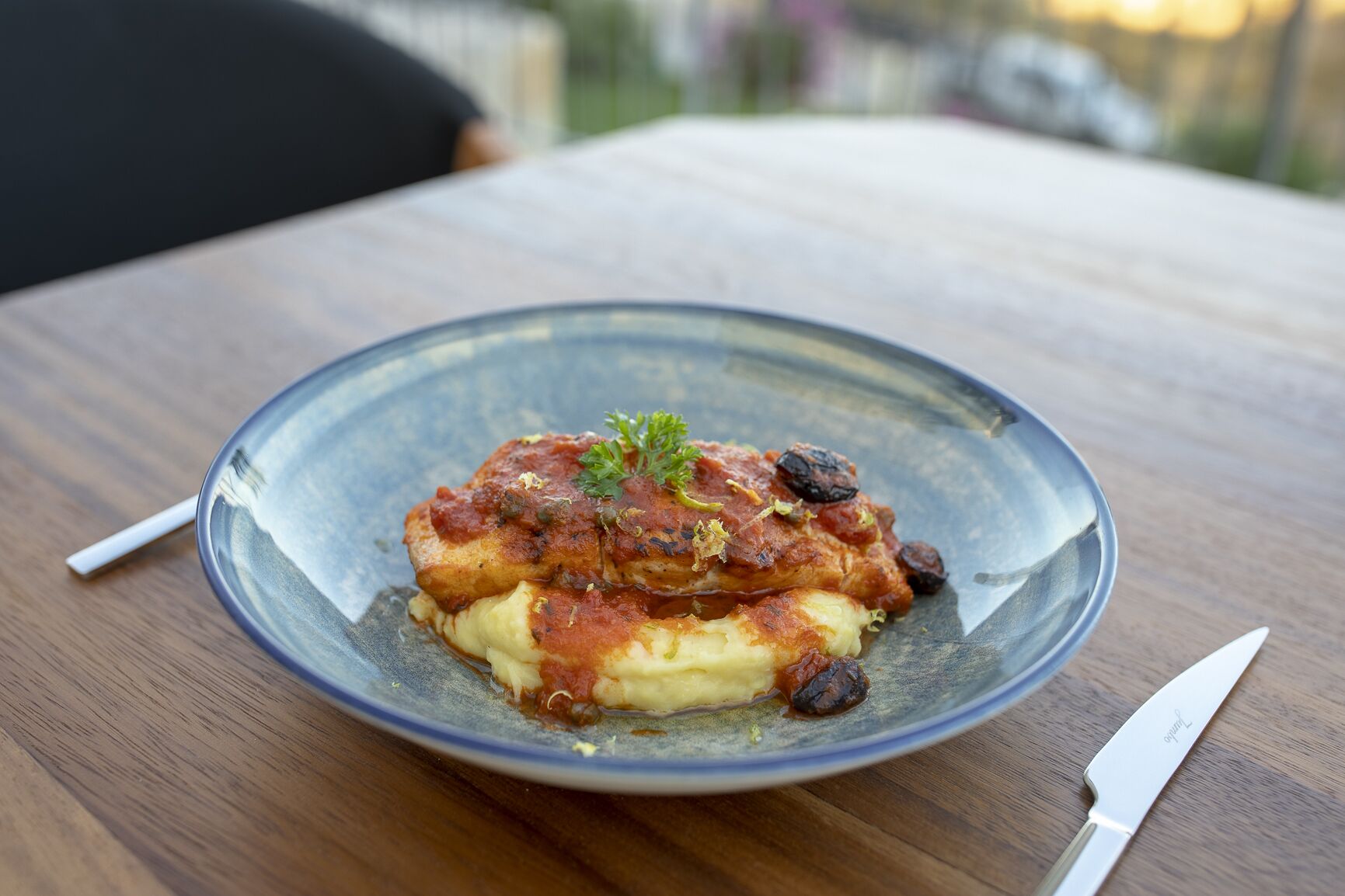 A plate of food on a wooden table.