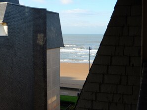 A view of a beach with a building in the foreground.