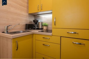 Fridge, stovetop, dishwasher, coffee/tea maker
