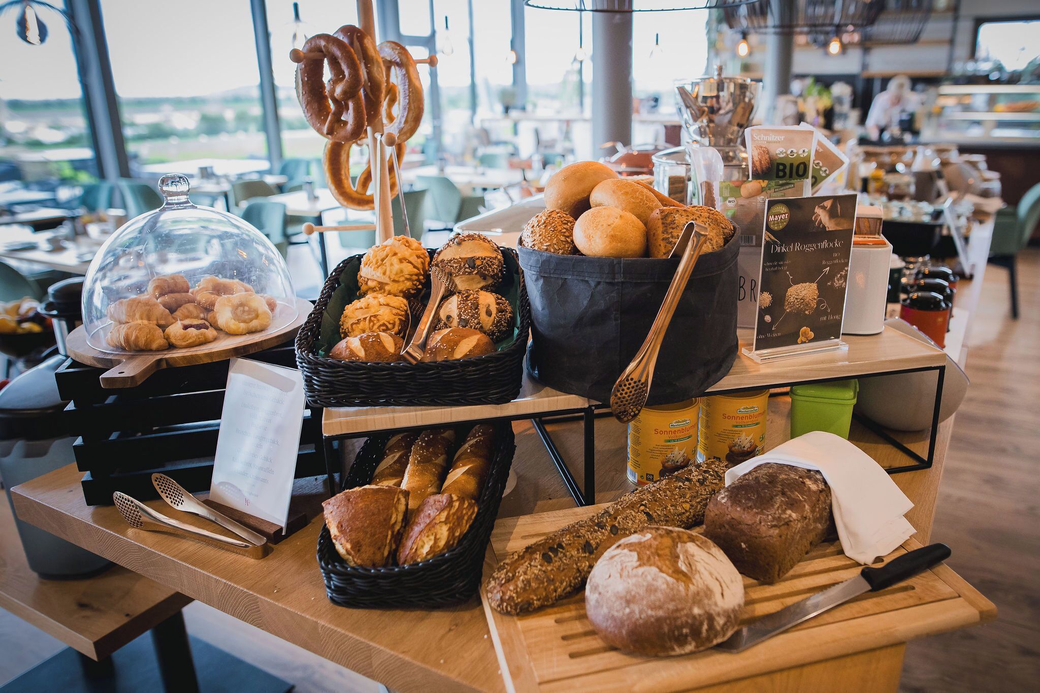 A bakery display with various breads and pastries.