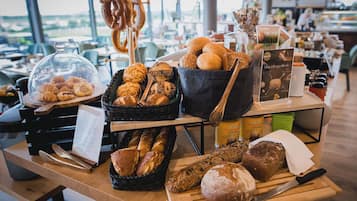 A bakery display with various breads and pastries.