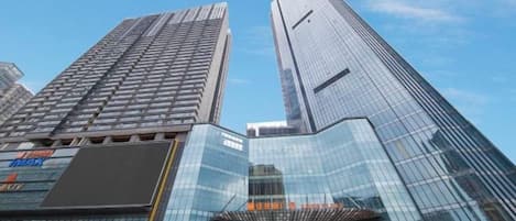 A modern building with a glass facade and a prominent vertical design element.