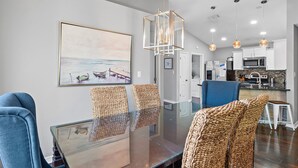 A modern kitchen with white cabinets, a microwave, and a stainless steel range hood. - 🐾Pet Friendly-Near Beach-4BR Shore Beats Work🐾 (Miramar Beach)