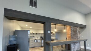 A modern kitchen with a built-in brick oven, grey cabinetry, and a water dispenser. - Riverside Loft with Huge Deck on GAP Trail (Confluence)