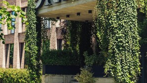 A building with a large sign reading "ONE66" and a staircase leading up to it. - One66 Hotel (Ljubljana)