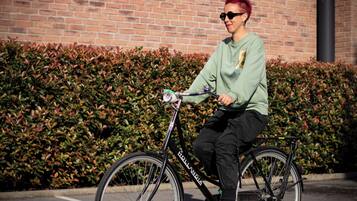 Una persona montando en bicicleta con un nombre de marca visible en el cuadro.