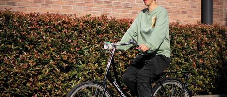 A person riding a bicycle with a visible brand name on the frame.