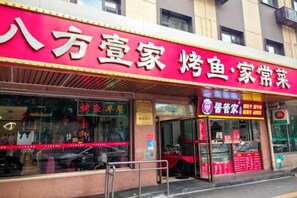 A storefront with a prominent red sign and a visible entrance.
