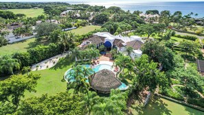 An aerial view of a resort with a swimming pool, palm trees, and a view of the ocean. - 5-star villa for rent in Moroccan-style (La Romana)