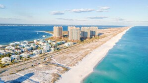 A coastal area with beachfront properties and high-rise buildings.