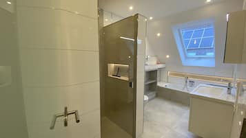 Bathtub, hair dryer, towels, soap