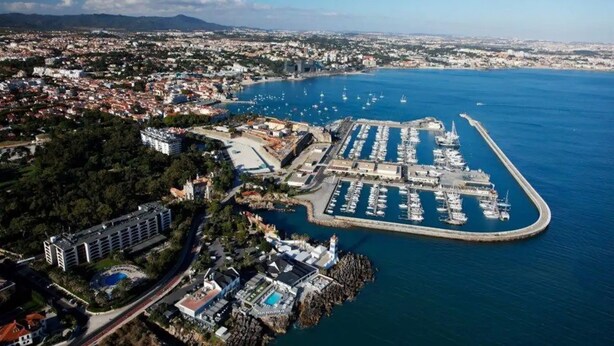 An aerial view of a coastal city with a marina, residential areas, and a large hotel complex. - Design Guincho Villa (Cascais)