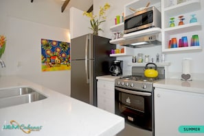 Enjoy cooking in this well-equipped kitchen with a gas stove, microwave, and refrigerator.