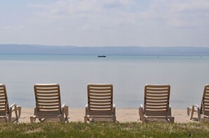 On the beach, sun-loungers