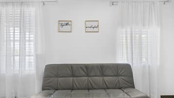Deluxe Studio | Living area | 50-inch Smart TV with cable channels, TV