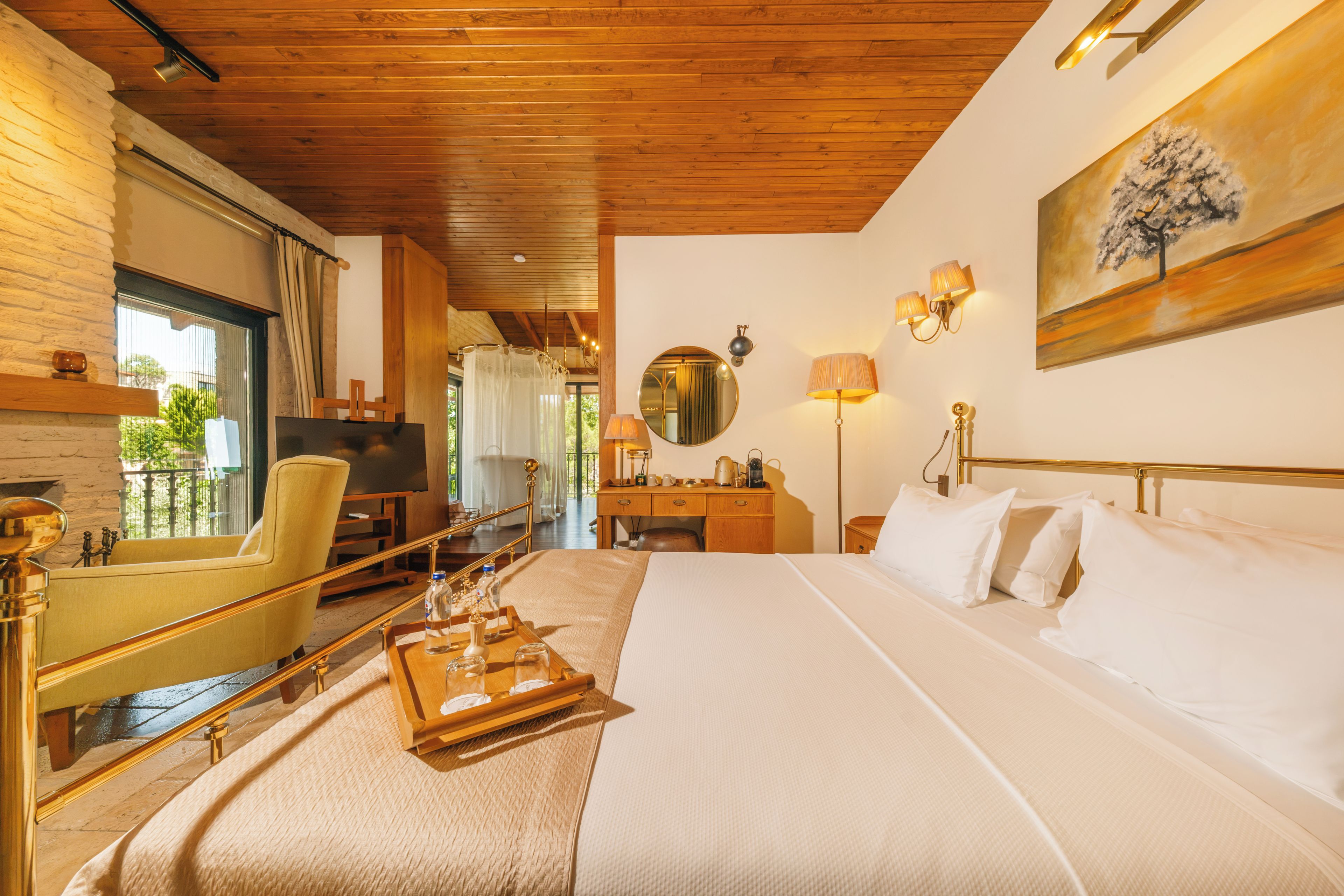 A hotel room with a bed, a desk, a chair, a television, and a window with curtains.
