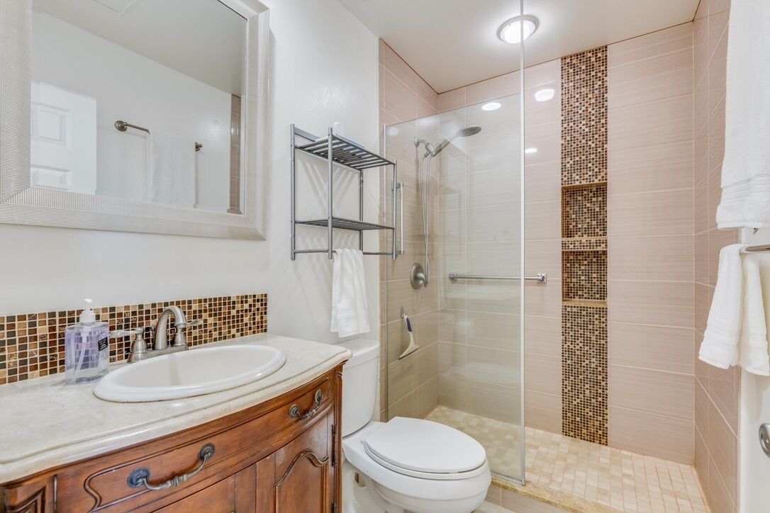 Bathtub, hair dryer, towels, toilet paper