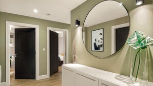 A hallway with a white console table, a round mirror, and a framed picture on the wall. - Apartment 293 - Clifden - sleeps 4 guests  in 2 bedrooms (Clifden)