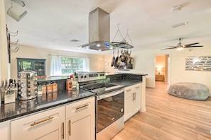 Enjoy cooking in this well-equipped kitchen with a central island, stainless steel stovetop, and oven.