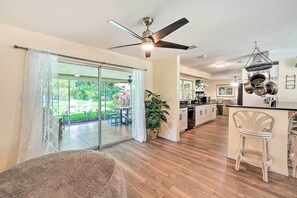 Enjoy cooking in this well-equipped kitchen with a central island, stainless steel appliances, and a dining area just through the glass door.