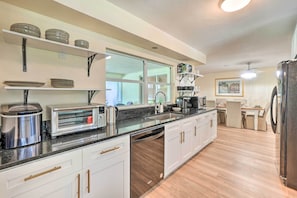 Enjoy cooking in this well-equipped kitchen with a dishwasher and stainless steel range hood.
