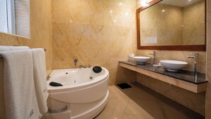A modern bathroom with a freestanding bathtub, two sinks, and a large mirror. - Kilua Residences by Cityblue (Mombasa)