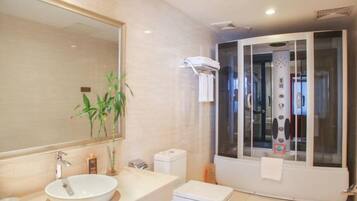 A modern bathroom with a large mirror, a white sink, a toilet, and a glass-enclosed shower area.