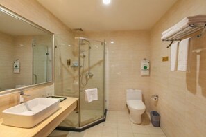 A modern bathroom with a glass-enclosed shower, a white sink, and a toilet. - Phoenix Hotel (Guangyuan)