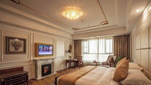 A hotel room with a large bed, a television, a fireplace, and a view of the outdoors. - Chongfu International Hotel (Shangcheng)