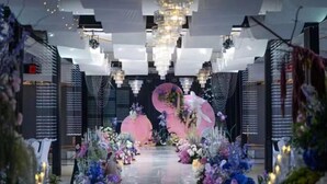 A venue with a central stage, floral arrangements, and chandeliers. - Chongfu International Hotel (Shangcheng)