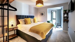 A modern bedroom with a bed, bedside table, and a hanging light fixture. - Bootham Row  11 -  a couples retreat that sleeps 3 guests  in 1 bedroom (York)
