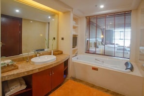 A bathroom with a large mirror, two sinks, a bathtub, and a window with blinds. - Jia Li Hotel (Dali)