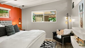 A bedroom with a bed, a chair, a ceiling fan, a window, and a wall-mounted lamp. - DreamCatcher-N Walk to Shop/Dine/Hike (Sedona)