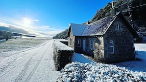 A stone cottage with a sloped roof, a small window, and a chimney. - The Lodge -  a lodge that sleeps 6 guests  in 3 bedrooms (Lochgilphead)