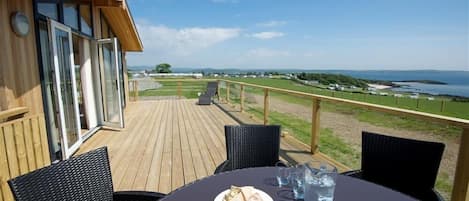 Enjoy a meal on the deck with a scenic view of the coastal landscape.