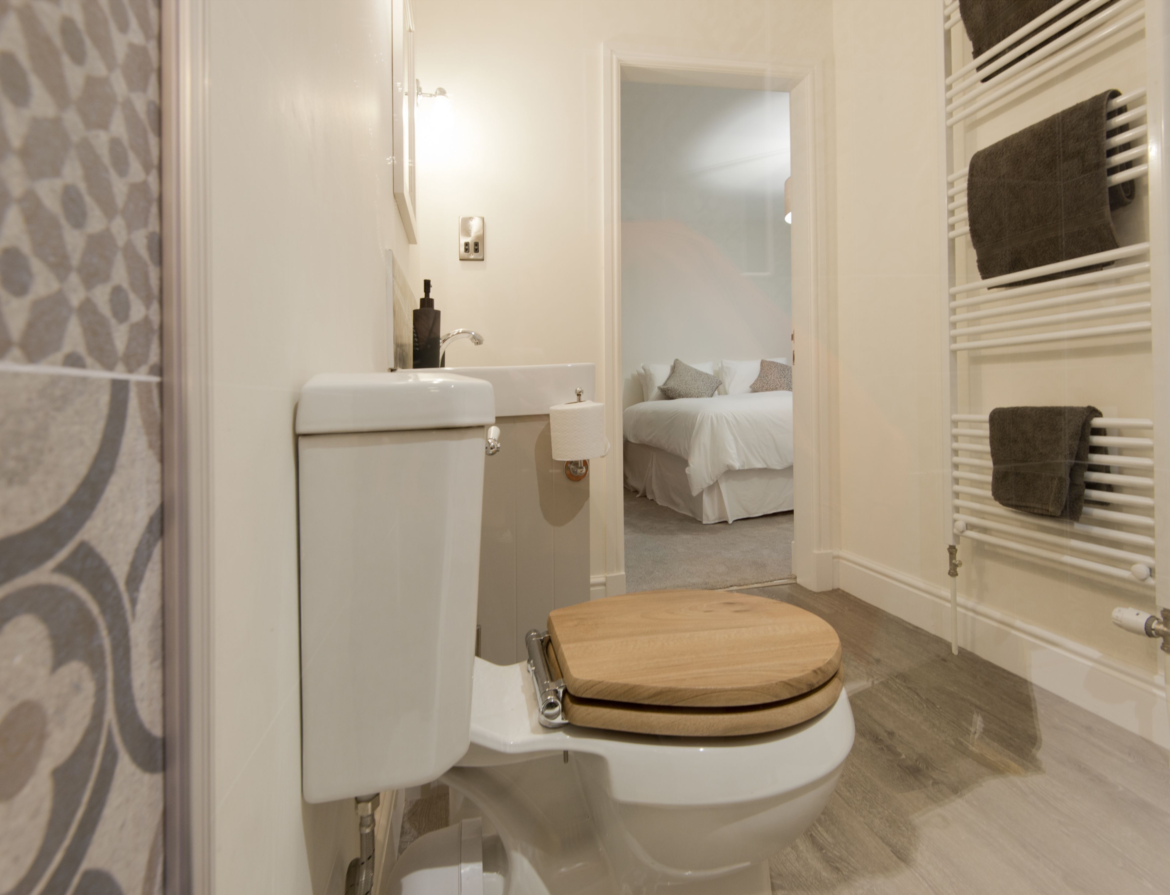 A bathroom with a toilet, a sink, and a shower area.