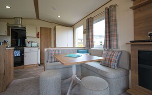 A compact kitchenette with a built-in oven, a microwave, and a coffee maker.