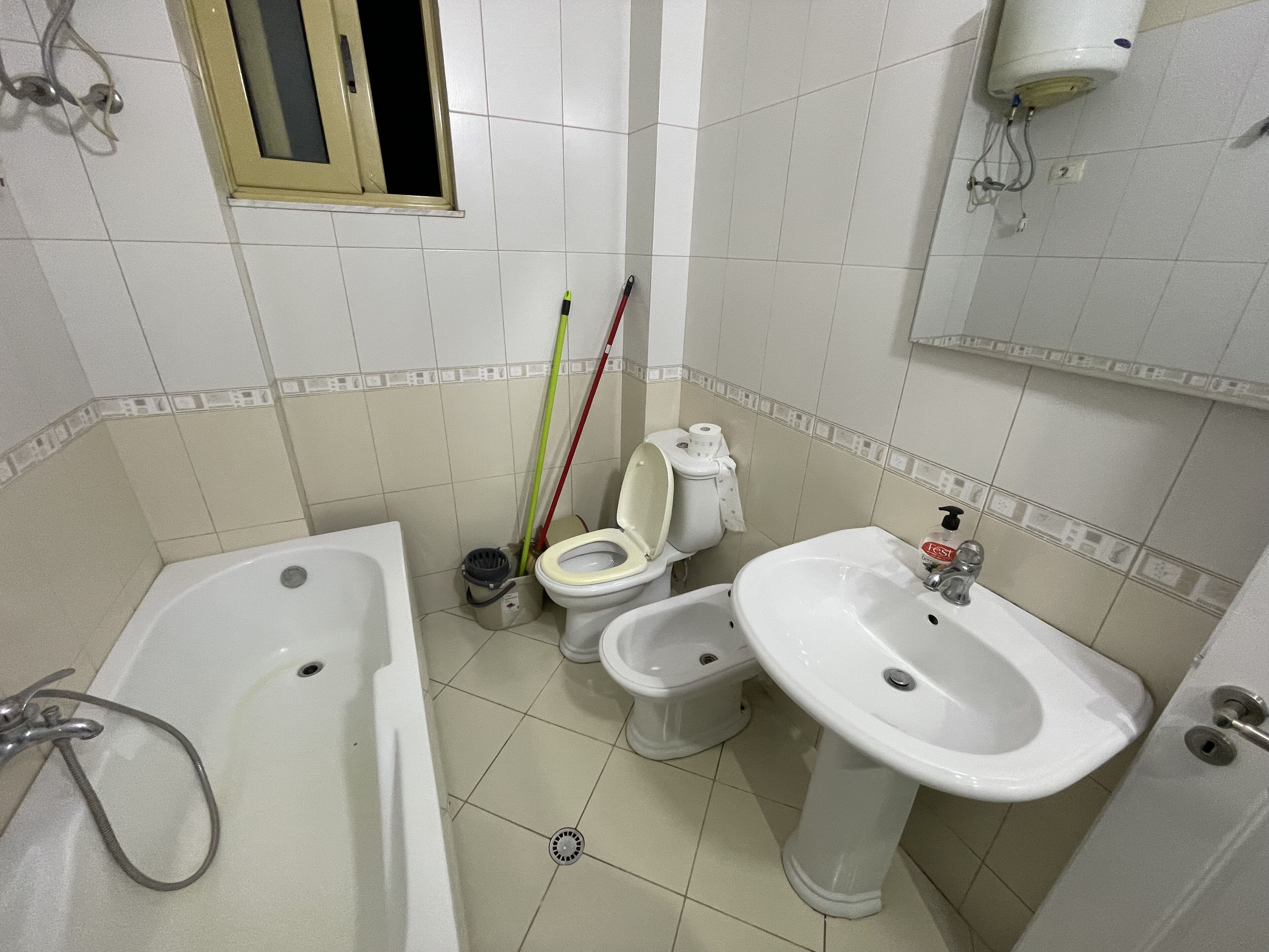 A bathroom with a bathtub, toilet, and sink.