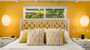 A bedroom with a bed, two bedside tables, a window with a view of greenery, and pendant lights. - DreamCatcher-S Uptown! Walk to Shop/Dine/Hike (Sedona)