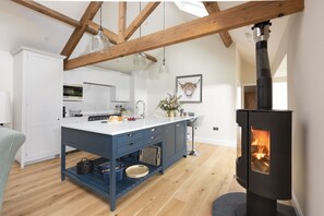 Enjoy cooking in this kitchen with a central island, stove, and large window.