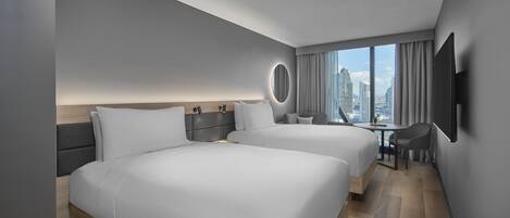 A modern hotel room with two beds, a desk, and a large window offering a city view.